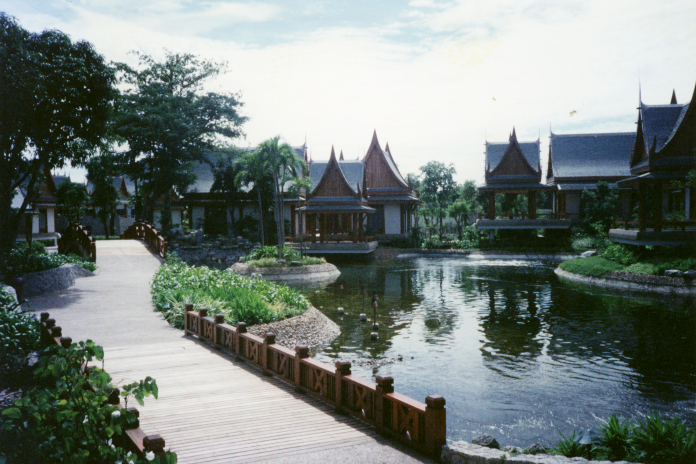 Lakeside villas with traditional roofs around water